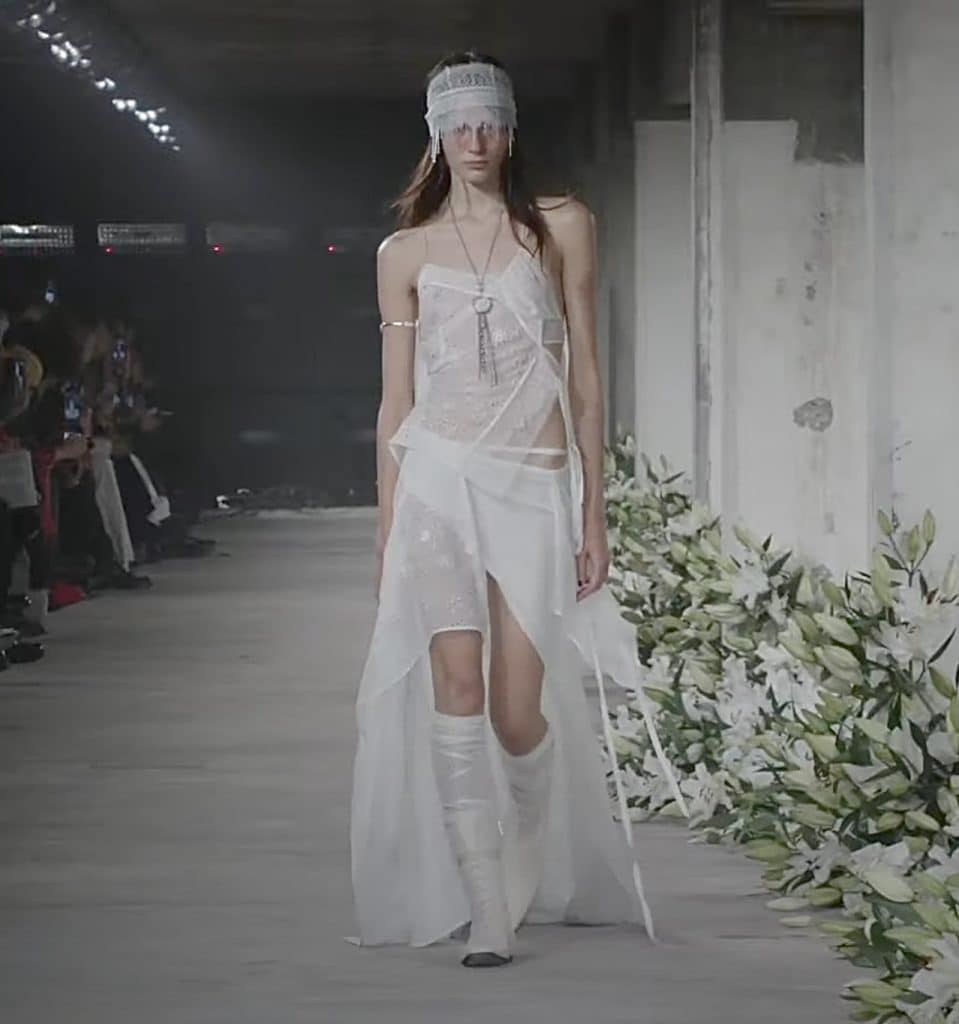 Paris fashion week 2024 model wearing a sheer white ensemble